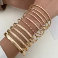 Polished gold alloy bangles set featuring hammered and twisted textures for a punk style - Gold (11760)
