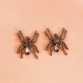 Gothic silver spider earrings with grey crystals on a soft peach satin background - Gray Rhinestone Spider Style (1051) / Antique Silver
