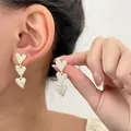 Detail of three tiered heart-shaped earrings with shimmering white cubic zirconia stones - 14K Gold Pave (5802)