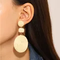 Handmade bohemian rattan earrings featuring three-tier natural woven circles on a model - Triple Circle Tiered (8657)