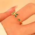 Close-up of golden leaf ring with green enamel details on a model hand - Green Leaf Open Ring (K-813) / Gold