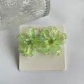 Chic Y2K iridescent light green resin iris flower earrings with sparkling rhinestone center - Light Green