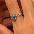 Detailed view of silver sea turtle and starfish open ring with blue gemstone on finger - Silver Turtle Starfish Open Ring (7034)