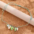 Collana intrecciata bohémien celeste con ciondoli a conchiglia e perle turchesi - Verde 9228