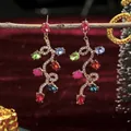 Elegant Christmas drop earrings with colorful gemstones on a festive red velvet background - Exaggerated Long Festive Christmas Earrings