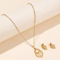Detail of gold-tone necklace and stud earrings set with hollow heart and bear charm design - Hollow Heart Bear (FX53) / Gold
