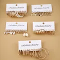 Detail of 24-piece vintage gold earring set with pearls and geometric charms - Gold Five Card Key Lock Snake Set (A-19)