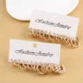 Detail of vintage gold earrings set with pearls on a fashion jewelry display card - Gold Two-Card Artificial Pearl Twist Hoop Set (FX916)