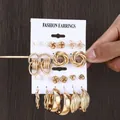 Close-up of 24-piece gold vintage earrings set with pearls on a fashion card display - Gold Butterfly Woven Heart Set (A-18)