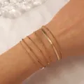 Set of six gold bohemian bracelets featuring snake and twisted chains on a wrist - Snake Twist Bead Combination (1845) / Gold
