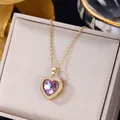 Elegant gold necklace with a heart-shaped purple crystal pendant and white zircon border - Heart of the Ocean