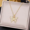 Elegant gold butterfly pendant necklace with cubic zirconia on champagne silk background - Full Zirconia Butterfly