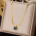 Golden snake bone necklace with emerald green gemstone displayed on jewelry box - Snake Chain Square Pendant
