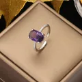 Close-up of luxury adjustable silver ring with oval purple gemstone and cubic zirconia - Purple-Silver
