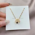 Macro shot of gold moon pendant with projection stone and zircon pave on silk background - Moon