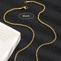 Detail of 45cm golden titanium rope chain with lobster clasp on black leather background - Thick Twist Chain / Gold