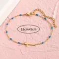 Goldenes Edelstahlarmband mit Kreuz und königsblauen Perlen und verstellbarer 5cm Kette - Blau