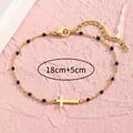 Goldenes Edelstahl-Armband mit Kreuzanhänger, schwarzen Perlen und verstellbarer Kette - Schwarz