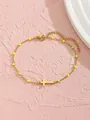Bracelet en acier doré avec pendentif croix et perles jaunes sur fond de pierre rose - Style Croix Horizontale