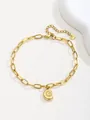 Detail of a gold paperclip chain anklet featuring a nautilus shell pendant and lobster clasp - Gold Conch