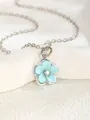 Detail of light blue enamel five-petal flower pendant with crystal center on silver chain - Blue Flower Style