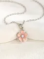 Macro detail of silver necklace featuring a pink flower pendant with a sparkling center stone - Flower - Pink