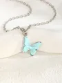 Macro shot of silver-tone chain necklace with light blue butterfly enamel pendant charm - Butterfly 1 - Blue