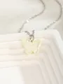 Macro view of light yellow butterfly pendant on a silver metal chain over white stand - White Butterfly 2