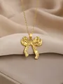 Elegant gold bow necklace with polished finish on premium champagne silk backdrop - Bowknot Style 1