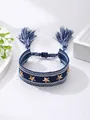 Bohemian navy blue woven bracelet featuring golden star studs and tassel charms - Blue Star Style