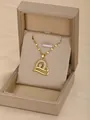 Collana dorata con ciondolo a cuore e cristalli bianchi in una scatola per gioielli - Cuore d'Oro