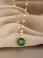 Macro shot of gold necklace with emerald square pendant and diamond accents on silk fabric - Gold Emerald Square Style(24)