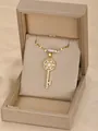 Golden key necklace with sparkling zircon flower detail in a premium jewelry gift box - Key-Gold