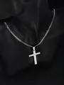 Macro shot of silver stainless steel cross pendant with engraved Lord Prayer on Cuban chain - Silver