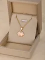 Chic golden necklace featuring a pink and white seashell pendant in a jewelry box - Scallop-Pink