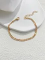 Elegant golden Figaro chain bracelet with lobster clasp on a white textured display tray - Gold Polished Figaro Style (SL60096-Gold) / Gold