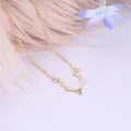Minimalist golden elk antler pendant necklace with small crystal on a soft pink background - Gold Reindeer Antlers
