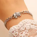 Silver elephant pendant necklace with Cuban chain shown on white lace cuff sleeve - Curb Chain Elephant Bracelet (6852) / White K