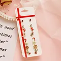 9-teiliges Weihnachts-Ohrstecker-Set mit Weihnachtsmann, Rentier und festlichen Motiven - Stock Stil Mehrfarbig