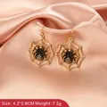 Gothic gold spider web earrings with black spider and crystals for Halloween decor - Gold Spider Web Style