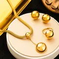 Close-up of polished gold-plated stainless steel jewelry set with spherical studs and necklace - Hemisphere Jewelry Set