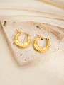 Detailed macro view of gold-plated chunky hoop earrings with engraved starburst texture - Round E0267 Style
