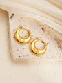 Macro shot of gold crescent earrings with sunburst texture on a stone surface - Round E0266 Style