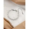 Silver braided stainless steel chain bracelet with lobster clasp on elegant silk background - 3-Strand Braided Bracelet / Silver