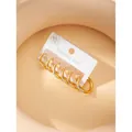 Three pairs of golden stainless steel hoop earrings with white zircon on display card - Circular Design / Gold
