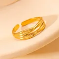 Close-up of golden multi-layer wrap ring with adjustable open design on a beige stand - Multi-layer Polished Intertwined (#0225)