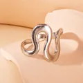 Close-up of minimalist wave ring in silver finish on a textured decorative stone - Abstract Wave Lines (BJGR0300)