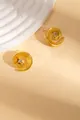 Detailed close-up of golden spiral earrings with zircon center on elegant stone texture - Ear Studs (E0558)