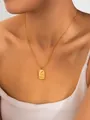 Close-up of gold snake chain necklace with rectangular moon and sun pendant on neck - Abstract Moon Necklace