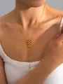 Detail of gold Y-shaped bow necklace with double flower pendants on model's neckline - Double Flower Y-Chain